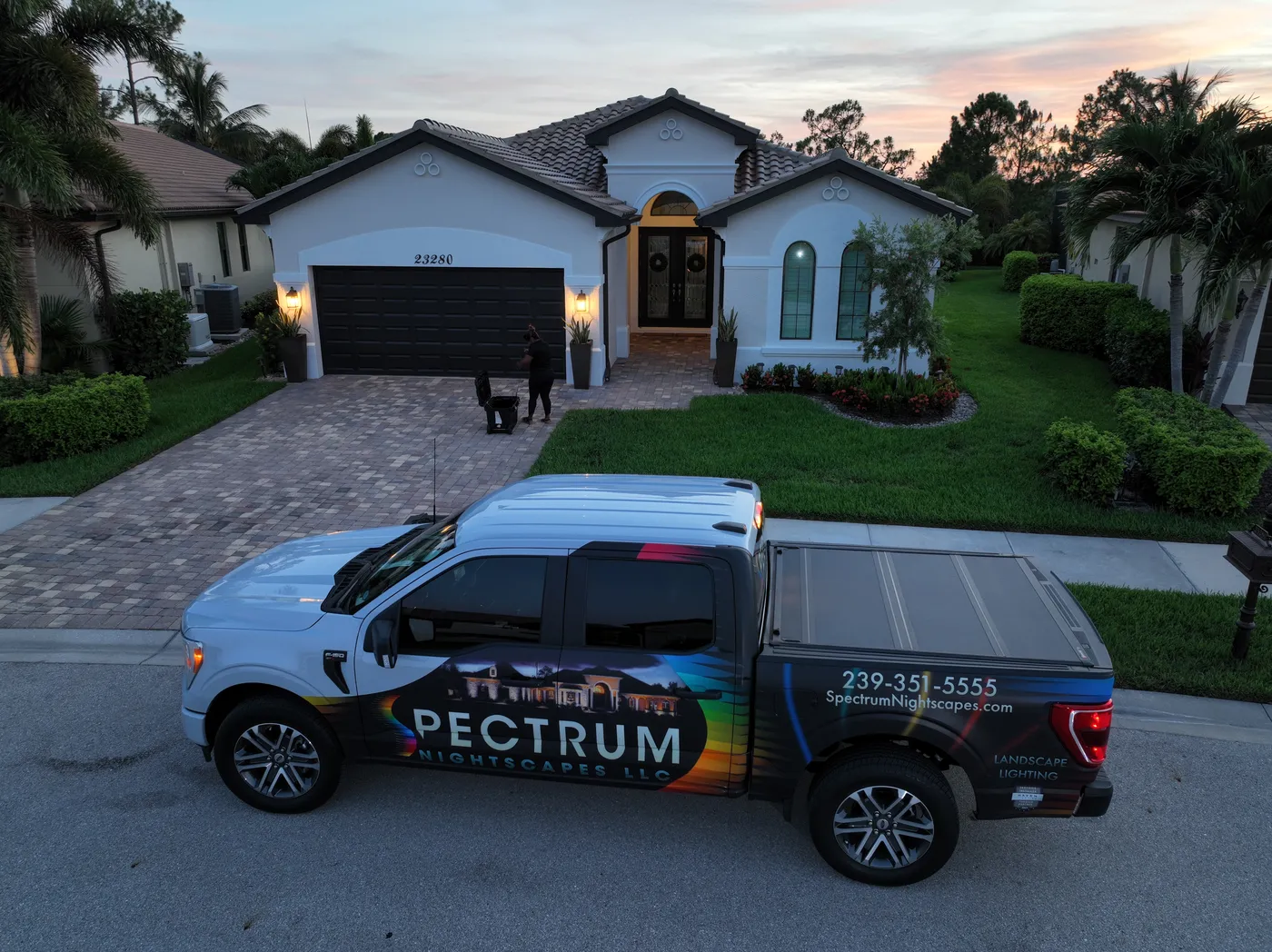 Spectrum Nightscapes wrapped truck at a Southwest Florida home at sunset