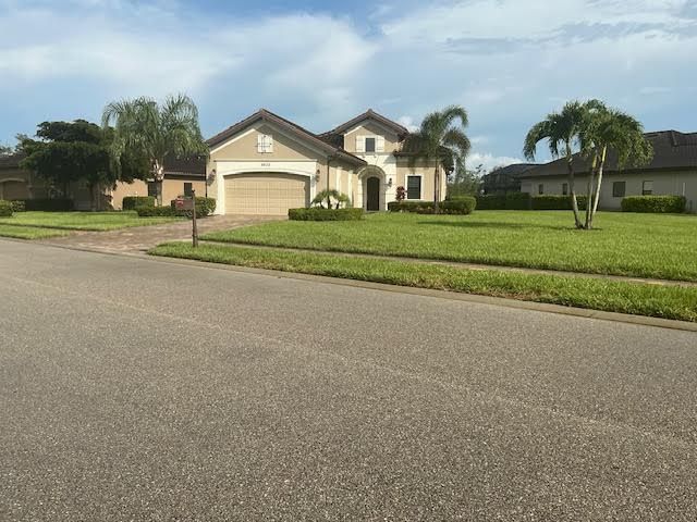 A daylight phone photo of a Naples home, taken from the street — the kind of photo a homeowner sends us to start.